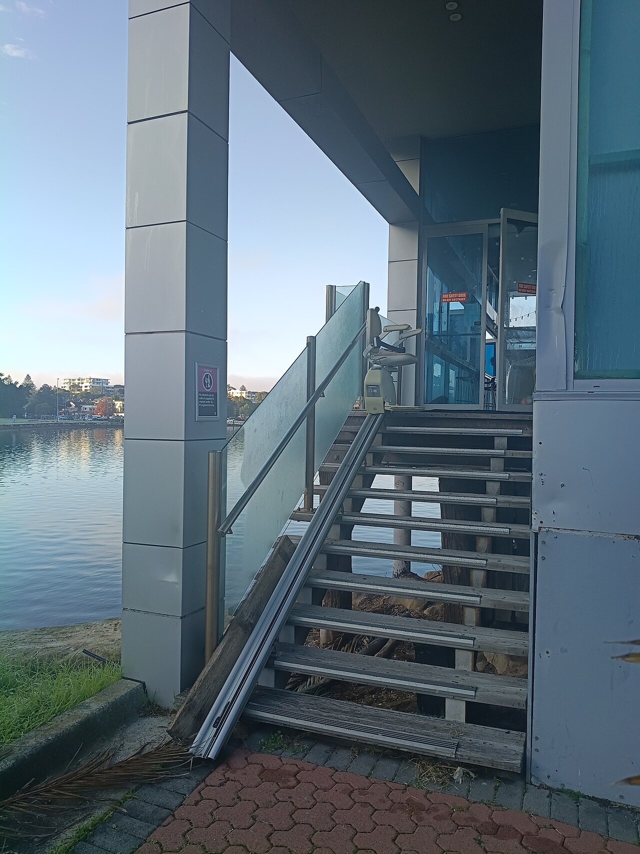 Real outdoor chair lift on exterior steps at Drifter’s Wharf in Gosford, Australia; not a local installation